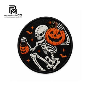 May include: A circular embroidered patch featuring a white skeleton on a black background. The skeleton holds a large orange jack-o'-lantern pumpkin and a smaller orange pumpkin bucket. The design includes orange stars and small orange bats.
