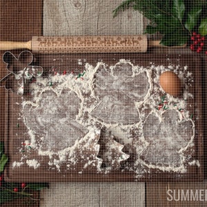 May include: A wooden cutting board with a rolling pin, cookie cutters, and flour. The cookie cutters are in the shape of a Christmas tree, a bell, and a star. There are red and green sprinkles on the board. The text "SUMMERANA" is visible in the bottom right corner of the image.