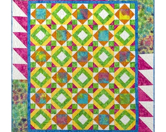 May include: A quilt featuring a repeating geometric pattern of squares and diamonds in vibrant shades of lime green, yellow, orange, and teal. The border consists of pink and white triangles, with corner sections displaying a floral sunflower print.