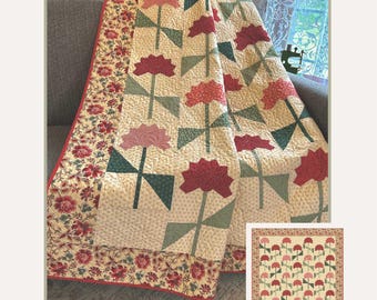 May include: A quilt featuring a floral pattern with red, pink, and green flower motifs on a cream background, bordered by a red and floral print fabric. The text reads Always In My Garden, 76 inches by 91.5 inches, and Sewing With Susan #363.