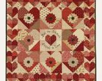 May include: A quilt pattern titled With all my Heart by Suzn Quilts, featuring a grid of red and cream heart blocks with floral centers. The text With all my Heart is at the top, and the dimensions 52 1/2 x 52 1/2 inches are printed at the bottom.
