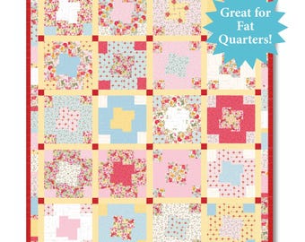 May include: A patchwork quilt featuring a grid of sixteen square blocks with diverse floral and geometric patterns in shades of pink, blue, yellow, and white. The blocks are separated by pale yellow sashing and small red cornerstones.