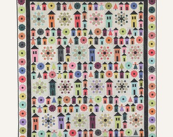 May include: A quilt pattern titled Dresden Village #282 by Suzn Quilts measuring 74 inches by 86 inches. The design features a grid of colorful houses, stylized flowers, and small figures on a light background with a dark floral border.