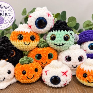 May include: A collection of small, plush, crocheted Halloween-themed figures including pumpkins, ghosts, eyeballs, and a Frankenstein-like character with large plastic eyes. A circular logo in the top left corner reads Crocheted by Candice.