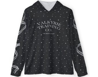 May include: A black long-sleeve hooded shirt featuring a white star pattern across the fabric. The chest displays the white text "VALKYRIE TRAINING CO." above "THE NIGHT COURT." The sleeves feature a white ribbon graphic design.