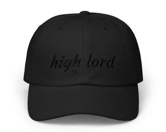 May include: A black baseball cap featuring the words high lord embroidered in a matching black thread across the front panel. The cap has a structured crown, a curved brim, and a button on top, maintaining a uniform monochromatic appearance.