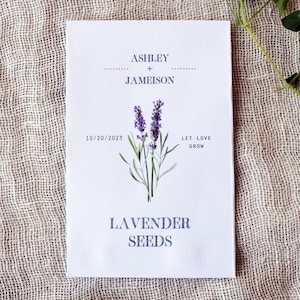 May include: White card with lavender flower illustration and the text "Ashley + Jamieson" and "Let Love Grow". The date "10/20/2023" is printed below the names. The bottom of the card reads "Lavender Seeds".