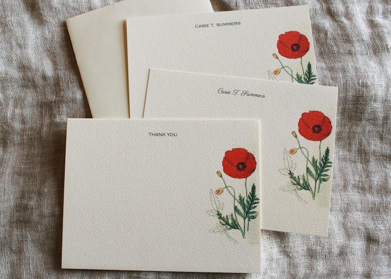 May include: Set of three blank stationery cards with a red poppy flower illustration and the name "Cassie T. Summers" printed on two of the cards. The third card says "Thank You".