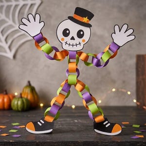 May include: A paper craft skeleton figure constructed from interlocking orange, purple, and lime green paper loops. The skeleton features a white skull with a black top hat, orange band, and yellow star, plus white hands and black shoes with orange toes.