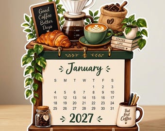 Puede incluir: Un calendario de enero de 2027 con ilustraciones de café, incluyendo una cafetera, un cruasán, un saco de granos y una taza con el texto 'But first Coffee'. Una pizarra pequeña muestra 'Good Coffee Better Days'.
