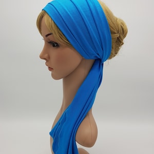 May include: A bright blue stretchy headband with a long tail that can be tied in a bow. The headband is made of a soft, comfortable fabric.