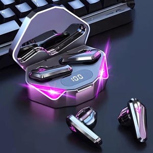 May include: A pair of metallic silver wireless earbuds with a matching charging case. The case features a digital display showing 100 and vibrant pink LED light accents. Two additional earbuds are placed in front of the open charging case.