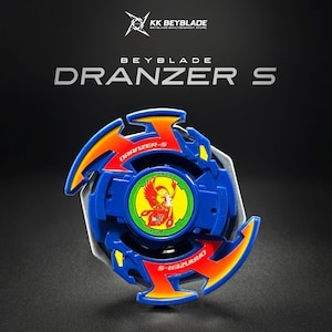 May include: A blue Beyblade Dranzer S spinning top featuring orange and yellow flame-like accents on the outer ring. The center emblem displays a red phoenix graphic on a green circular background with the text Dranzer S printed on the blades.