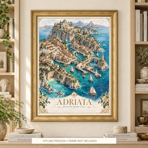 May include: A framed art print titled Adriata, Jewel of the Summer Court, featuring a detailed watercolor-style map of a coastal Mediterranean-inspired town with cliffs, turquoise water, sailboats, and stone architecture in a gold-toned frame.