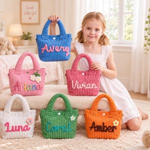 May include: Six corduroy tote bags in blue, pink, rose, white, green, and orange. Each bag features a white snap closure, two handles, and a personalized name in colorful felt lettering. Some bags include small decorative felt flower accents.