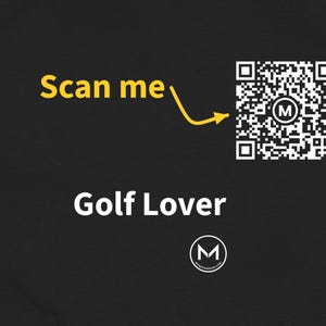 May include: A black fabric surface featuring the white text Golf Lover, a yellow arrow pointing to a square QR code with a central M logo, the yellow text Scan me, and a small circular logo with the letter M and text below it.