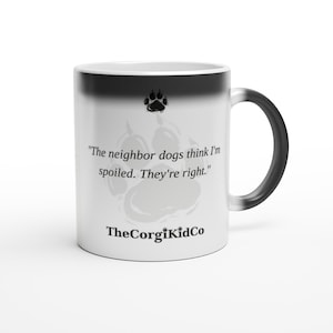 Puede incluir: Una taza de cerámica blanca con borde y asa en degradado negro. Presenta un icono de huella negra, el texto "The neighbor dogs think I'm spoiled. They're right." en fuente serif negra y el texto negro "TheCorgiKidCo" en la parte inferior.