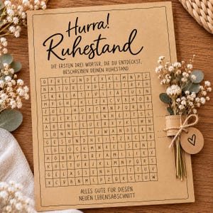 May include: A rectangular tan card featuring the German text Hurra! Ruhestand and a word search puzzle. Below the grid, the text reads Alles Gute für diesen neuen Lebensabschnitt. A small bouquet of dried white flowers is attached to the right side.