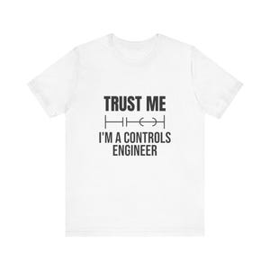 May include: A white short-sleeve t-shirt featuring black text that reads TRUST ME I'M A CONTROLS ENGINEER, with a graphic of a ladder logic contact symbol positioned between the two lines of text on the front of the garment.