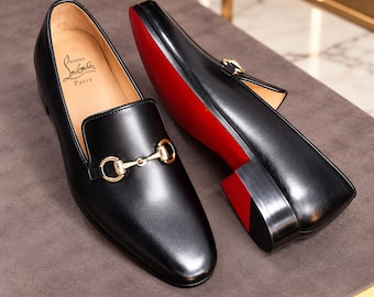 Christian Louboutin black leather horsebit loafers, featuring a slip-on design and a red sole