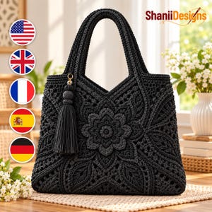 May include: A black crochet handbag featuring an intricate floral pattern and a matching black tassel attached to the handle. The bag displays the text ShaniiDesigns in the upper right corner and includes five circular flag icons on the left.