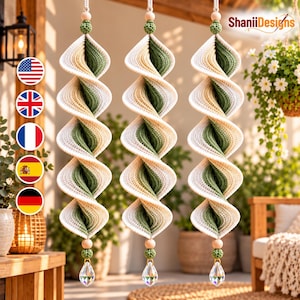 May include: Three hanging spiral ornaments featuring a crochet design in alternating cream and sage green colors. Each piece is topped with a wooden bead and a small green crochet sphere, and finished at the bottom with a clear crystal teardrop.