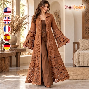 May include: A long, brown, open-front crochet duster cardigan featuring a collar, long bell sleeves, and intricate floral and leaf lace patterns throughout the hem and front placket. The garment is worn over a matching brown top and trousers.