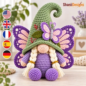 May include: A crochet gnome doll featuring a tall, pointed green hat adorned with a small butterfly and red berries. The doll has a round peach-colored nose, two long cream-colored braided pigtails, a purple body, and large purple butterfly wings.