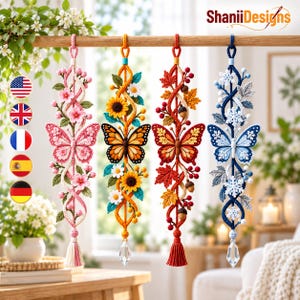 May include: Four vertical hanging ornaments featuring butterflies and seasonal motifs. From left to right: pink cherry blossoms, yellow sunflowers, red autumn leaves with acorns, and blue snowflakes. Each piece includes a dangling crystal or tassel.