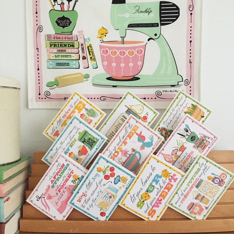 May include: A set of colourful recipe cards with illustrations and text. The cards feature phrases like "add a little spice to your", "wake up and smell the coffee", "let your lemons be sour and your words be sweet", and "much of our future lies in preserving our past".