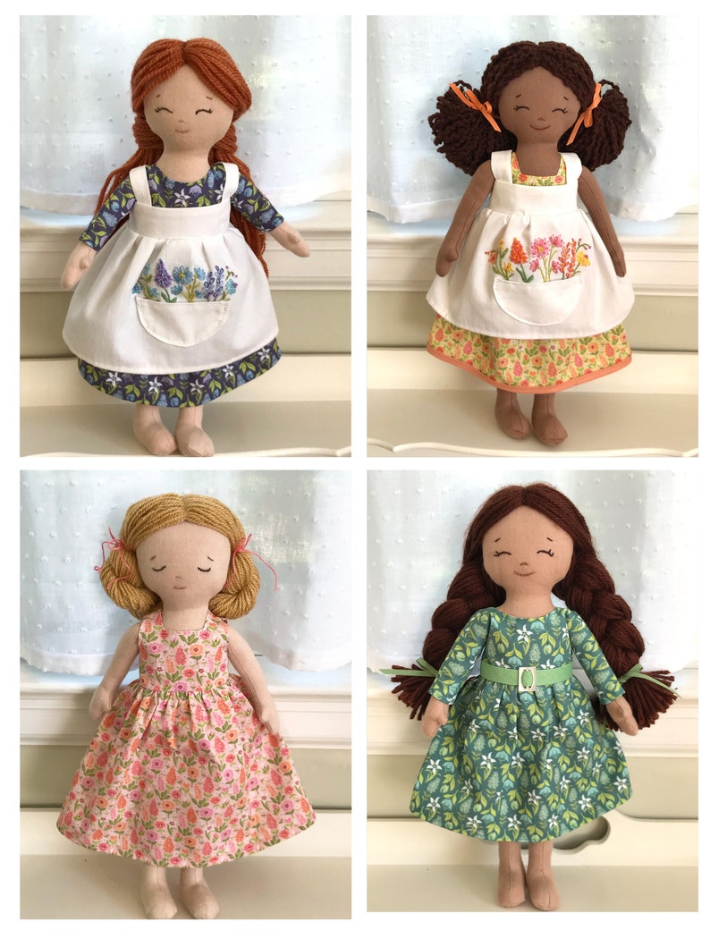 May include: Four handmade fabric dolls with different hair colors and clothing. Each doll is wearing a dress with a floral pattern. The dolls are standing on a white surface.