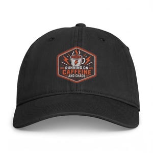 May include: A black baseball cap featuring an embroidered hexagonal patch on the front. The patch displays a white coffee mug with a lightning bolt, surrounded by orange lightning symbols, and the text RUNNING ON CAFFEINE AND CHAOS.