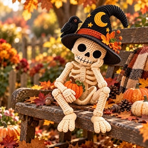 May include: A crocheted skeleton figure wearing a black witch hat decorated with a yellow crescent moon, stars, and orange autumn leaves. The skeleton has a small black bird perched on the hat and is holding a small orange crocheted pumpkin.