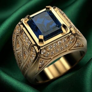 May include: A gold ring featuring a large, rectangular, deep blue gemstone set in the center. The band and setting are decorated with intricate gold patterns and numerous small, clear, sparkling stones embedded along the sides and edges.