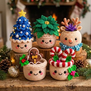 May include: Five crocheted amigurumi figures featuring a blue Christmas tree with white pearls, a green poinsettia, a tan reindeer with antlers, a brown gingerbread person, and a container with red and white striped candy canes.