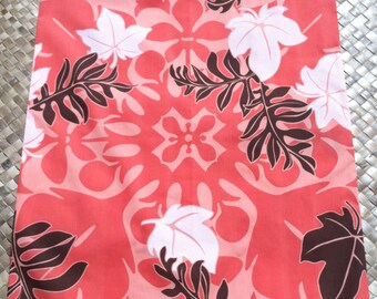 May include: A pink fabric with a brown and white floral pattern. The fabric has a repeating pattern of leaves and flowers.
