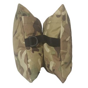 May include: A dual-chambered shooting rest bag featuring a camouflage pattern in shades of tan, brown, and green. The two sections are connected by a black nylon strap with a black plastic D-ring attached to the side for secure positioning.