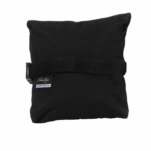 May include: A square black fabric cushion featuring a horizontal black nylon strap with a plastic buckle closure. A small black label is attached to the side, displaying the white text Prestige and the white text MADE IN THE UK below it.