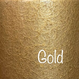 May include: A close-up of a textured gold surface with the word "Gold" written in white.