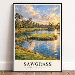 May include: A framed art print depicting a golf course island green surrounded by water at sunset. The scene features tall pine trees, a wooden bulkhead, and a sand bunker. The text at the bottom reads SAWGRASS FLORIDA 30.20 N 81.39 W.