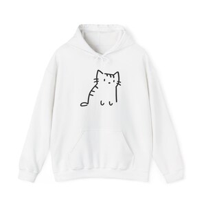 May include: A white long-sleeve hooded sweatshirt featuring a simple black line drawing of a cat on the front. The hoodie includes a front kangaroo pocket, a drawstring hood, and ribbed cuffs at the sleeves and hem, providing a clean look.