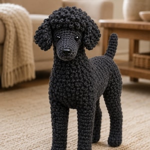 May include: A black poodle figurine crafted with crochet yarn, featuring a textured curly coat, floppy ears, a pointed tail, and two dark eyes. The dog stands in a fixed position with a detailed snout and a small black nose, showcasing intricate stitching.