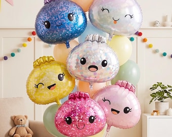 May include: A festive balloon bouquet featuring several foil balloons shaped like smiling dumplings in blue, yellow, pink, and iridescent white, mixed with round latex balloons in pastel colors, all tied together with curling ribbons.
