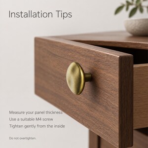 May include: A round, brushed brass cabinet knob attached to a dark wood drawer. Text on the image reads: Installation Tips, Measure your panel thickness, Use a suitable M4 screw, Tighten gently from the inside, Do not overtighten.
