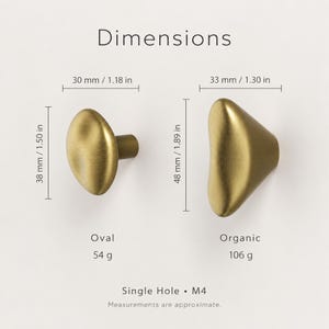 May include: Two brass-toned cabinet knobs labeled Dimensions. The oval knob is 1.18 inches wide and 1.50 inches high, weighing 54 grams. The organic-shaped knob is 1.30 inches wide and 1.89 inches high, weighing 106 grams. Both are single hole M4.