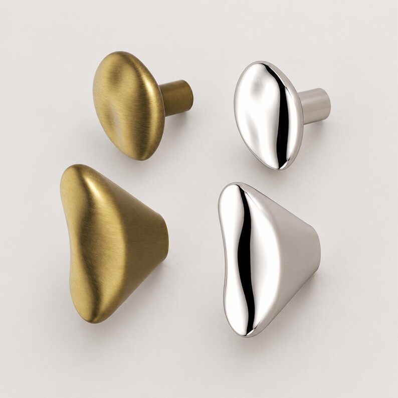 May include: A set of four cabinet knobs featuring two distinct organic, irregular shapes. Two knobs have a brushed brass finish, while the other two have a polished chrome finish. Each knob includes a cylindrical base for mounting to a surface.
