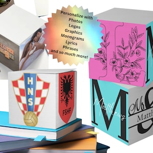 May include: A collection of personalized wooden blocks with various designs. One block features the text "custom design", another displays a photo, and others showcase monograms, logos, and graphics. The blocks are stacked on books.