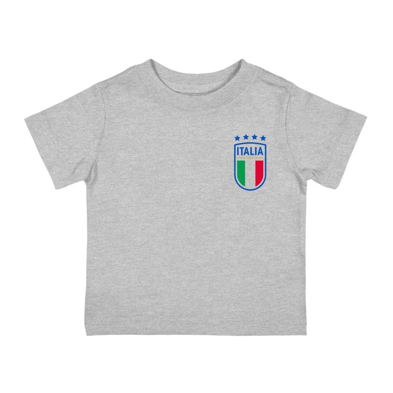 May include: A gray short-sleeved t-shirt with a blue and white Italian soccer team logo on the left chest. The logo features the Italian flag and the word "ITALIA" with five stars above it.