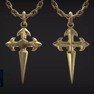 May include: Two gold-toned metal cross pendants on matching chains. The left pendant features a central scallop shell motif, while the right pendant displays a smooth, polished surface. Both crosses have pointed bases and ornate arms.