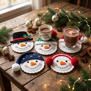 May include: A set of four round, white crocheted snowman coasters. Each features a unique winter accessory: a black top hat with holly, a green beanie, a blue nightcap with stars, and red earmuffs. Each snowman has a carrot nose and pink cheeks.
